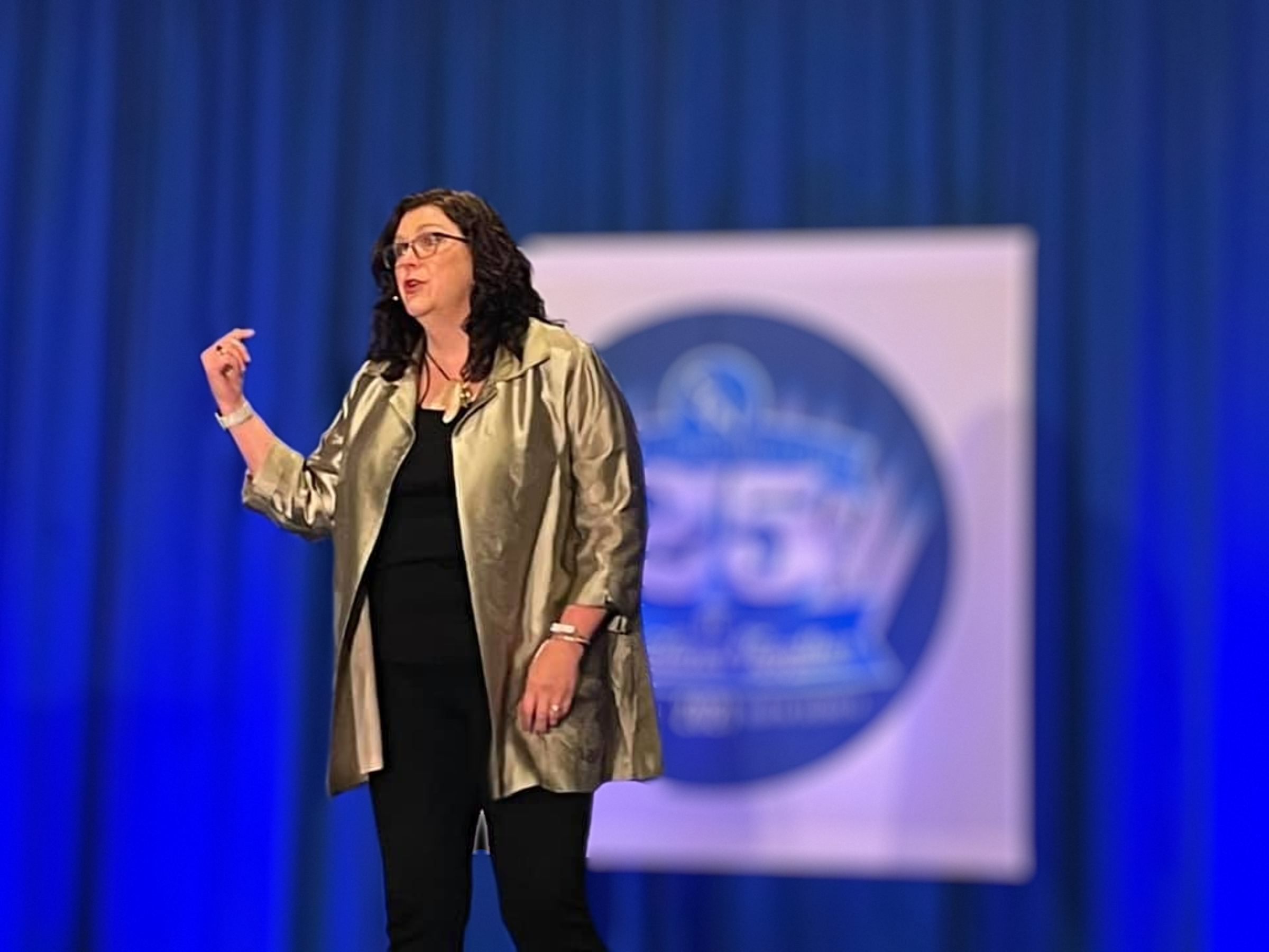 Penny Reed speaking on stage